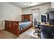 Bedroom with wooden bed frame and workspace at 3815 Landgraf Cv, Decatur, GA 30034