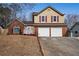 Two-story house with a two-car garage and a neatly landscaped yard at 3815 Landcraf Cv, Decatur, GA 30034