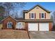 Brick and beige two-story house, two-car garage, and a sloping yard at 3815 Landgraf Cv, Decatur, GA 30034