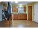 Kitchen boasts wood cabinets, tile floors and a modern refrigerator at 3815 Landcraf Cv, Decatur, GA 30034