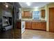 Kitchen features wood cabinets, tile floors and modern appliances at 3815 Landcraf Cv, Decatur, GA 30034