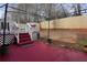 Red patio with pergola and stairs leading to deck at 3815 Landcraf Cv, Decatur, GA 30034