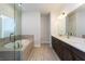 Modern bathroom with double vanity, a soaking tub and a glass shower at 5015 Montes Ln, Cumming, GA 30040