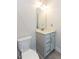 Modern bathroom with gray vanity, quartz countertop and a toilet at 5015 Montes Ln, Cumming, GA 30040