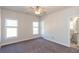 Bright bedroom with neutral walls, ceiling fan, and en-suite bathroom at 5015 Montes Ln, Cumming, GA 30040