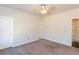 Spacious bedroom with neutral walls, ceiling fan and carpet flooring at 5015 Montes Ln, Cumming, GA 30040