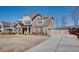 Stylish home with a long driveway, gray siding, brick accents and well-maintained landscaping at 5015 Montes Ln, Cumming, GA 30040