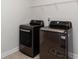 Laundry room with LG washer and dryer, and overhead shelving at 5015 Montes Ln, Cumming, GA 30040