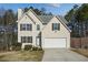 Two-story house with attached garage and landscaped yard at 6738 Merrywood Dr, Fairburn, GA 30213