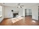 Living room with hardwood floors, fireplace, and ceiling fan at 6738 Merrywood Dr, Fairburn, GA 30213