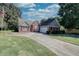 Brick ranch home with a large front yard and driveway at 1809 Francon Sw Ct, Conyers, GA 30094