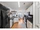 Modern kitchen with white cabinets, black countertops, and stainless steel appliances at 1809 Francon Sw Ct, Conyers, GA 30094