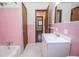 Pink bathroom with tub, toilet, and vanity at 2283 Country Club Sw Ln, Atlanta, GA 30311