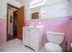 Pink tiled bathroom with white vanity and toilet at 2283 Country Club Sw Ln, Atlanta, GA 30311