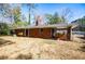 Brick ranch house with covered patio, spacious backyard, and mature trees at 2283 Country Club Sw Ln, Atlanta, GA 30311