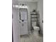 Bathroom features a modern vanity with a sleek black faucet and a metal shelving rack for storage at 28 Samuel Nw Way, Cartersville, GA 30121