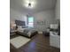 Bright bedroom featuring a tufted headboard, hardwood floors, cozy rug, and bright natural light at 28 Samuel Nw Way, Cartersville, GA 30121