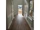 Hallway with hardwood floors, wainscotting, and view of the front door and staircase at 28 Samuel Nw Way, Cartersville, GA 30121