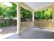 Covered back porch with wood railing and view of the backyard at 301 Fortune Ne St, Atlanta, GA 30312