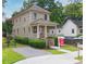 Charming two-story home features a welcoming front porch, lush landscaping, and a 'Coming Soon' sign at 301 Fortune Ne St, Atlanta, GA 30312