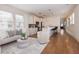 Open-concept living room with a view into the kitchen, featuring hardwood floors, and neutral decor at 301 Fortune Ne St, Atlanta, GA 30312