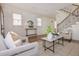 Open-concept living room highlighting hardwood floors, a staircase, and lots of natural light at 301 Fortune Ne St, Atlanta, GA 30312