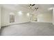 Main bedroom with high ceilings, grey carpet, and ceiling fans at 332 Stonecutters Cv, Stockbridge, GA 30281