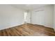 Well-lit bedroom with wood-look flooring and double doors to closet at 332 Stonecutters Cv, Stockbridge, GA 30281