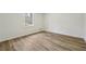 Simple bedroom with wood-look flooring and a window at 332 Stonecutters Cv, Stockbridge, GA 30281