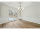 Dining room with hardwood floors and French doors leading to deck at 332 Stonecutters Cv, Stockbridge, GA 30281