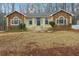 Ranch home with stone accents and a landscaped yard at 332 Stonecutters Cv, Stockbridge, GA 30281