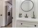 Modern bathroom with a white vanity, black matte fixtures, and a round mirror at 537 N Cedar N Ct, Riverdale, GA 30274