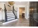 Bright entryway with a grand staircase, dark wood railings, and luxury vinyl plank flooring at 537 N Cedar N Ct, Riverdale, GA 30274