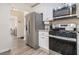 Modern kitchen with white cabinets, stainless steel appliances, and granite countertops at 537 N Cedar N Ct, Riverdale, GA 30274