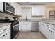 Modern kitchen with white cabinets, stainless steel appliances, and granite countertops at 537 N Cedar N Ct, Riverdale, GA 30274