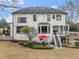 The back exterior features a patio with stairs to the porch and a well-manicured lawn at 6310 Fox Creek Dr, Cumming, GA 30040