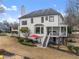 The back exterior features a patio, yard with an outdoor seating, and a staircase to the porch at 6310 Fox Creek Dr, Cumming, GA 30040