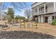 A backyard with a pergola, seating area, firepit, and lush landscaping at 6310 Fox Creek Dr, Cumming, GA 30040