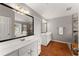 Well-lit bathroom featuring dual vanities, a walk-in shower, and sleek design elements at 6310 Fox Creek Dr, Cumming, GA 30040