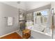 Bright bathroom with a soaking tub, a walk-in shower, and natural light from the window at 6310 Fox Creek Dr, Cumming, GA 30040