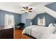 Cozy bedroom featuring blue walls, wood floors, and a comfortable bed at 6310 Fox Creek Dr, Cumming, GA 30040