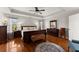 Spacious bedroom featuring hardwood floors, a ceiling fan, and a large window at 6310 Fox Creek Dr, Cumming, GA 30040