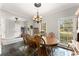 Bright and airy dining room with a large window, stylish decor, and plenty of seating space at 6310 Fox Creek Dr, Cumming, GA 30040