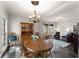 Elegant dining room featuring a large wooden table, classic chandelier, and ample natural light at 6310 Fox Creek Dr, Cumming, GA 30040