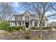 Charming two-story home with a cozy front porch, shutters, and professionally landscaped front yard at 6310 Fox Creek Dr, Cumming, GA 30040