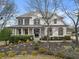 Lovely two-story home with a welcoming front porch, beautiful landscaping, and mature trees at 6310 Fox Creek Dr, Cumming, GA 30040