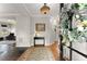 Welcoming foyer with hardwood floors, decorative lighting, and a glimpse into the living spaces at 6310 Fox Creek Dr, Cumming, GA 30040