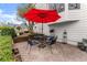 Outdoor patio with table and chairs, featuring a red umbrella for shade at 6310 Fox Creek Dr, Cumming, GA 30040