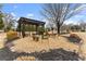 Cozy backyard with a pergola, seating area, and a stone firepit surrounded by mature trees at 6310 Fox Creek Dr, Cumming, GA 30040