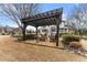 A covered pergola area with outdoor seating provides an inviting space for relaxation and entertaining at 6310 Fox Creek Dr, Cumming, GA 30040